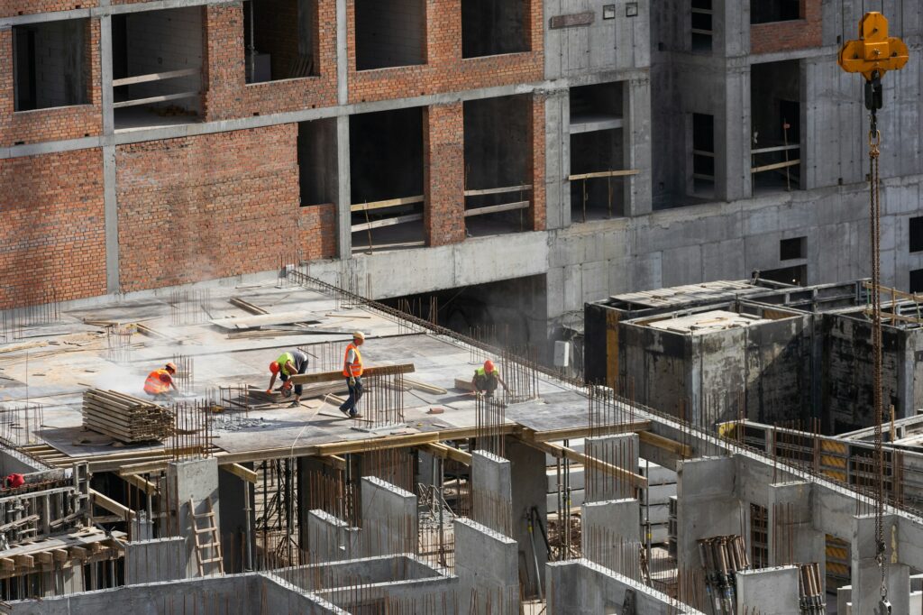 Construction worker Concrete pouring during commercial concreting floors of building in construction